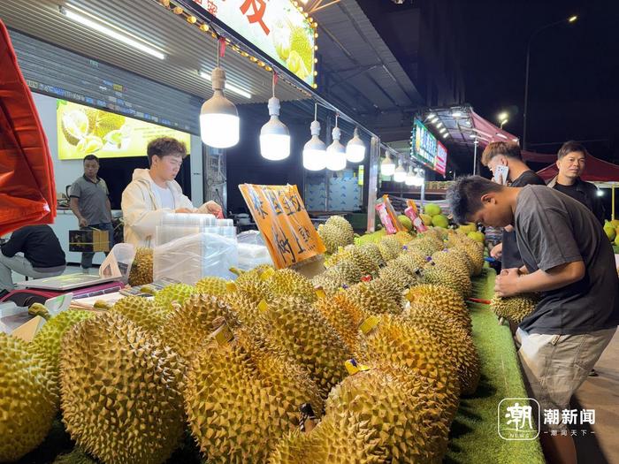 商户正在帮顾客挑选榴莲。 潮新闻记者 李稀 摄